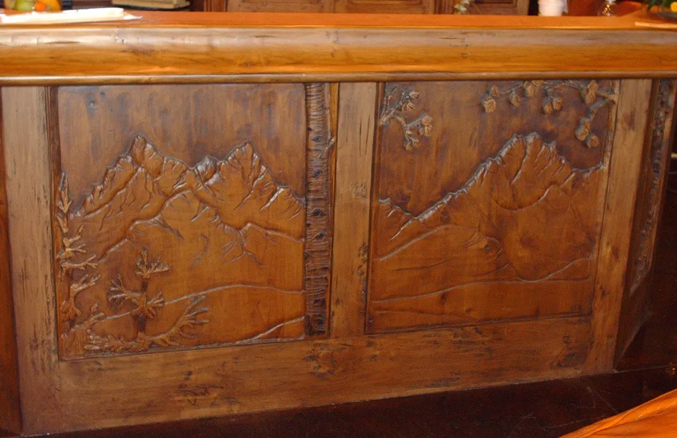Hand carved mountainous landscape on bar